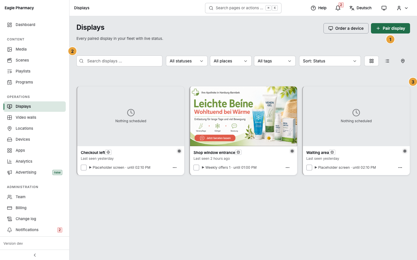 The Displays page after pairing: the “Pair display” button at the top right (1), below it the search, status, tag, and sort selection with the choice of view (2), and the tiles of the paired displays, at the right one that is currently playing its playlist (3)